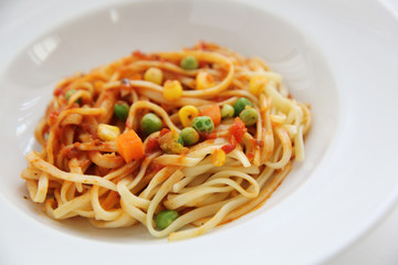 Fettuccine pasta in tomato sauce isolated in white background