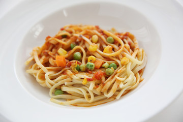 Fettuccine pasta in tomato sauce isolated in white background