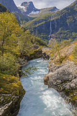 Fototapeta na wymiar Picturesque mountain valley with turbulent river near Briksdal glacier, Norway