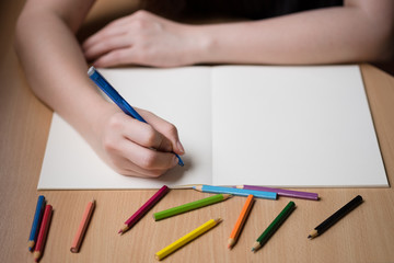 Woman hand writing on blank book