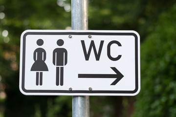 A WC sign isolated on a pole