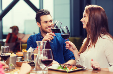 couple dining and drinking wine at restaurant