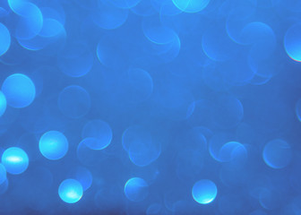 Blue bokeh light is the soft blurred circles of light white and light blue . Winter Christmas background texture Wallpaper concept