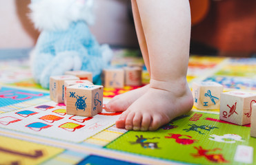 Obraz premium child little girl playing wooden toys at home or kindergarten