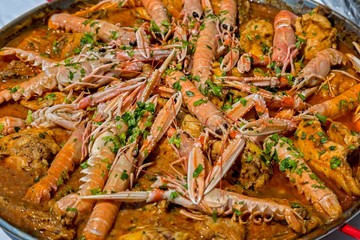 Paella with seafood and vegetables in a pan