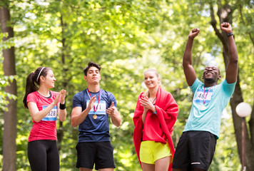 Group of young fit friends happy after finishing race.