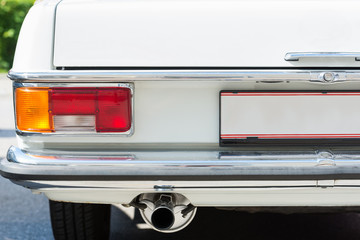 left rear side old a white german automobile coupé mercedes benz 220D , close up