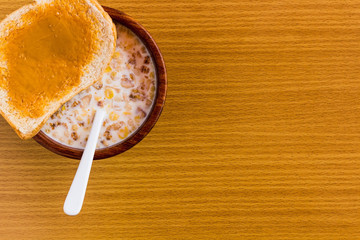 peanut butter and breakfast on wood table