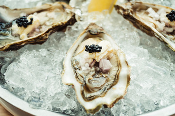 Raw and fresh Oyster with caviar on top and lemon