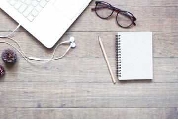 Creative flat lay design of workspace with white laptop on wood table