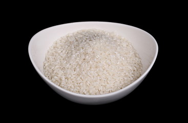 White rice in a bowl isolated on black background