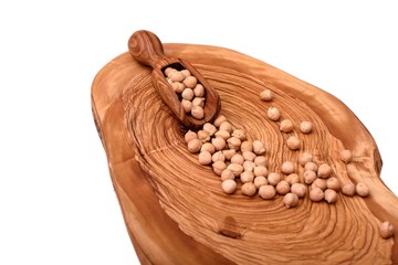 Chickpeas on wooden board isolated on white background