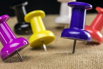 Macro shot of multi colored push pins