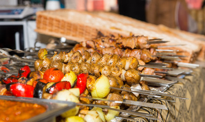 Bounty of cooked meats and vegetables arranged neatly on metal platters