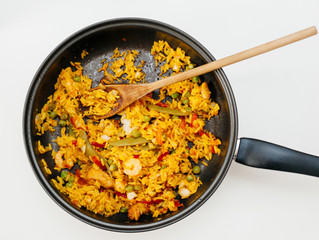 high angle view of paella in pan on table - ready to eat spanish food made from fresh ingredients in home conditions, home made organic lunch or dinner