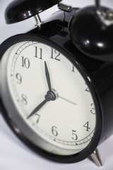 Black, vintage alarm clock with qwhite background