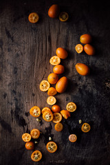 Fototapeta na wymiar Whole and halved oranges, overhead view 