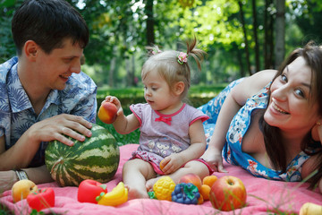 Fototapeta na wymiar Happy family on picnic in the Park, eat watermelon, fruits