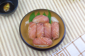 Japanese food, fresh tuna and Wasabi sauce on wooden plates and handkerchiefs.