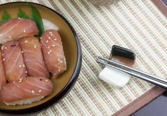 Japanese food, fresh tuna on wooden plate and chopsticks.