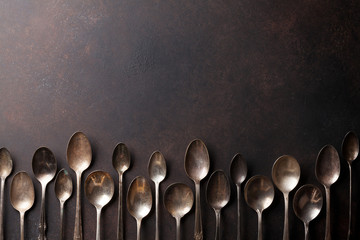 Old vintage spoons on stone table