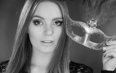 Woman holding carnival mask closeup