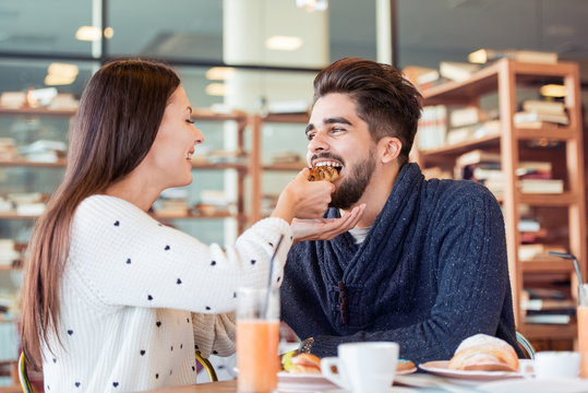 Couple enjoying meal sitting at cafe table