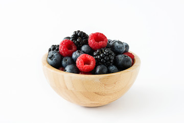 Healthy berries in wooden bowl isolated on white background
