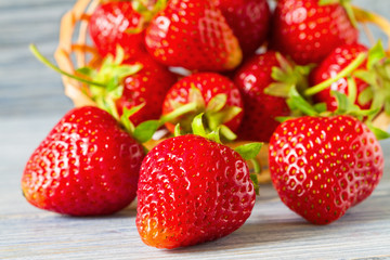 Fresh ripe strawberries on the blue wooden background. Selective focus. Closeup.