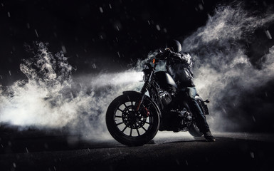 Fototapeta na wymiar High power motorcycle chopper with man rider at night