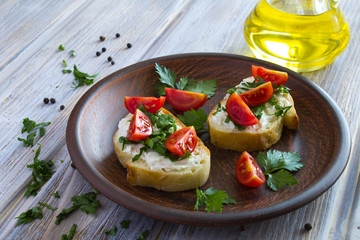 Sandwiches with tomato,cheese and parsley in the brown plate on the wooden background