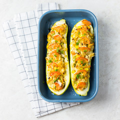 Zucchini casseroles in a baking dish on concrete background. 