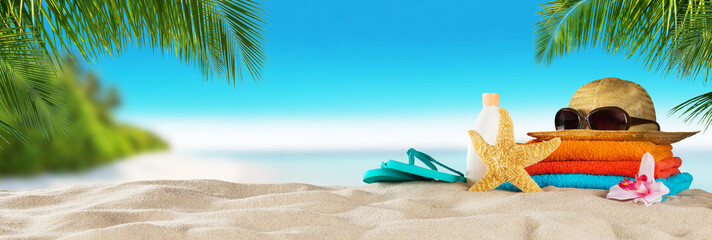 Fototapeta premium Tropical beach with accessories on sand, summer holiday background.