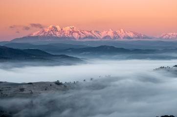 Fototapeta na wymiar panorama over misty Spisz highland to snowy Tatra mountains in the morning, Poland landscape