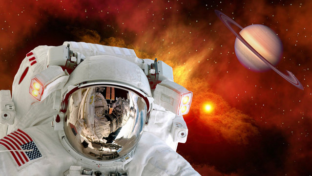 Astronaut planet Saturn spaceman helmet stars space suit galaxy universe. Elements of this image furnished by NASA.