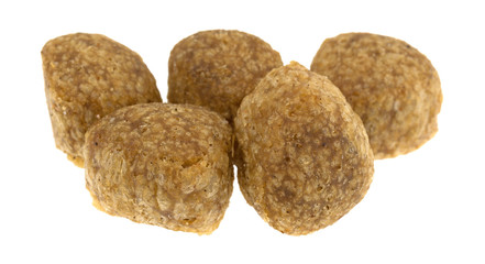Portion of chicken meatball dog food isolated on a white background.