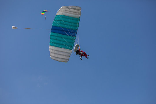 skydivers parachutist on blue sky on sunset