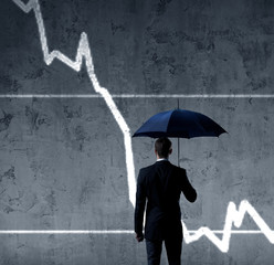 Businessman with umbrella standing over diagram background. Business, insurance, risk, concept.