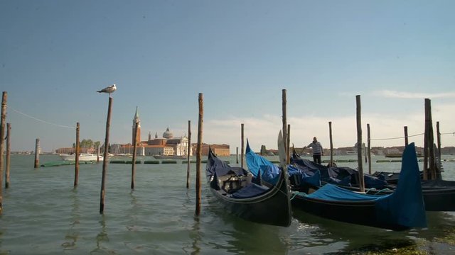 April 2017 - Gondolas and view to Chiesa di San Giorgio Maggiore Church of San Giorgio Maggiore and Fondazione Giorgio Cini right before the sunset in Venice, Italy