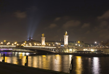 Night view of Grand Palais (Palace), Pont Alexandre III bridge and and Seine river in Paris.