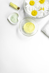 Spa composition with salt, chamomile and towel copyspase top view white background vertical