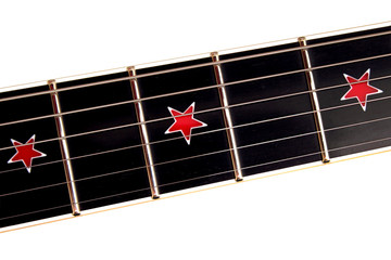 Guitar fretboard with stars close up top view of an electric guitar neck and strings on white...
