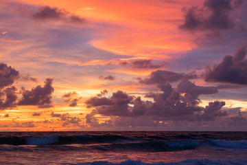 Naklejka na ściany i meble Dark pink dramatic sunset in clouds over the sea