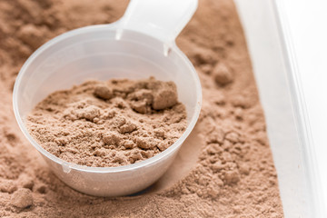 nutrition for workout with protein cocktail powder on white background close up