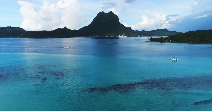 Aerial view of Bora Bora in French Polynesia with cruise ships, coral lagoon sea and Mount Otemanu Mt Pahia, Mount Otemanu, Tahiti, south Pacific Ocean. Boat and ship.