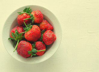 Fresh ripe strawberries in bowl on white background, copy space
