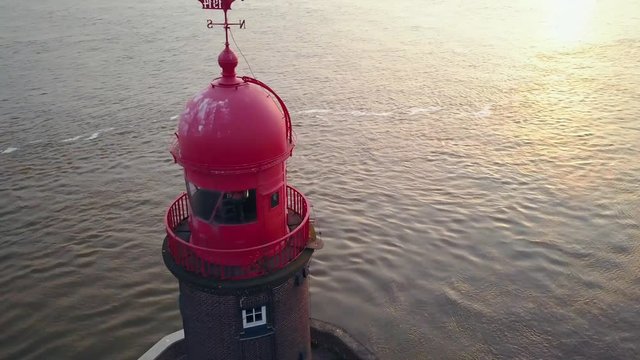 Flying past a lighthouse in germany at sunset