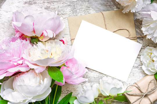 blank greeting card and envelope with pink and white peonies and roses and gift box