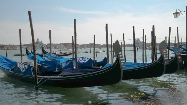 April 2017 - Gondolas and view to Chiesa di San Giorgio Maggiore Church of San Giorgio Maggiore and Fondazione Giorgio Cini right before the sunset in Venice, Italy
