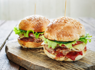Homemade burgers on wooden background